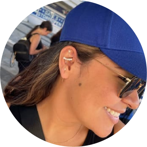 Person wearing a blue cap and sunglasses with a blurred background