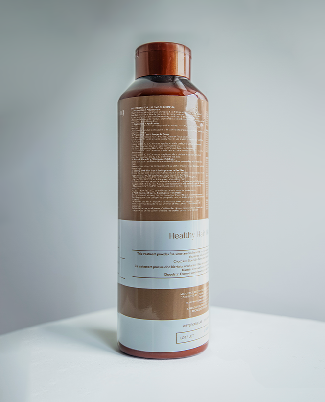 Bottle with a brown label on a white surface and light gray background