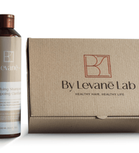 Shampoo bottle and box from By Levane Lab on a white background